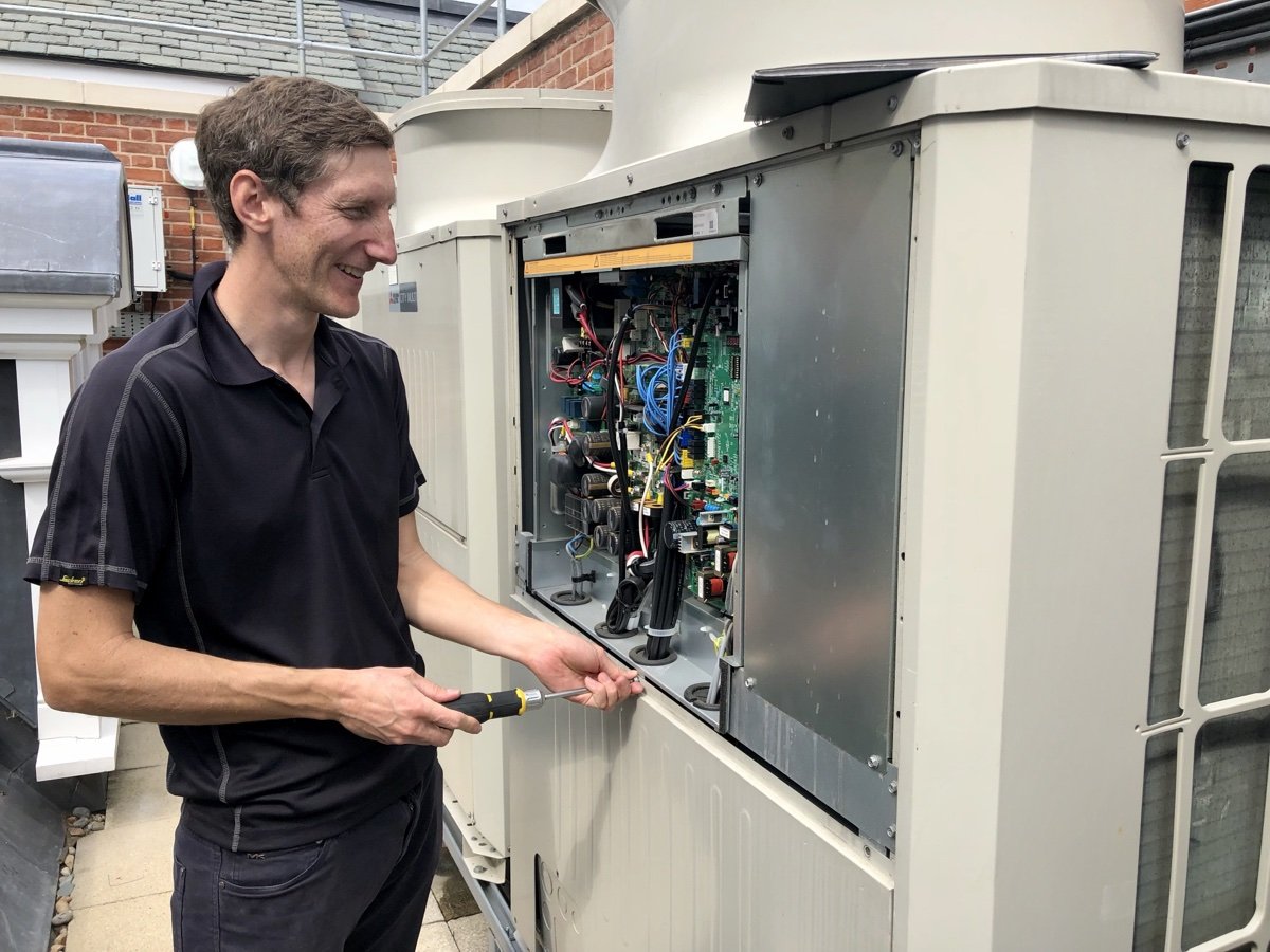 Andy, TJB Air Conditioning owner, on site with a Mitsubishi City Multi VRV unit
